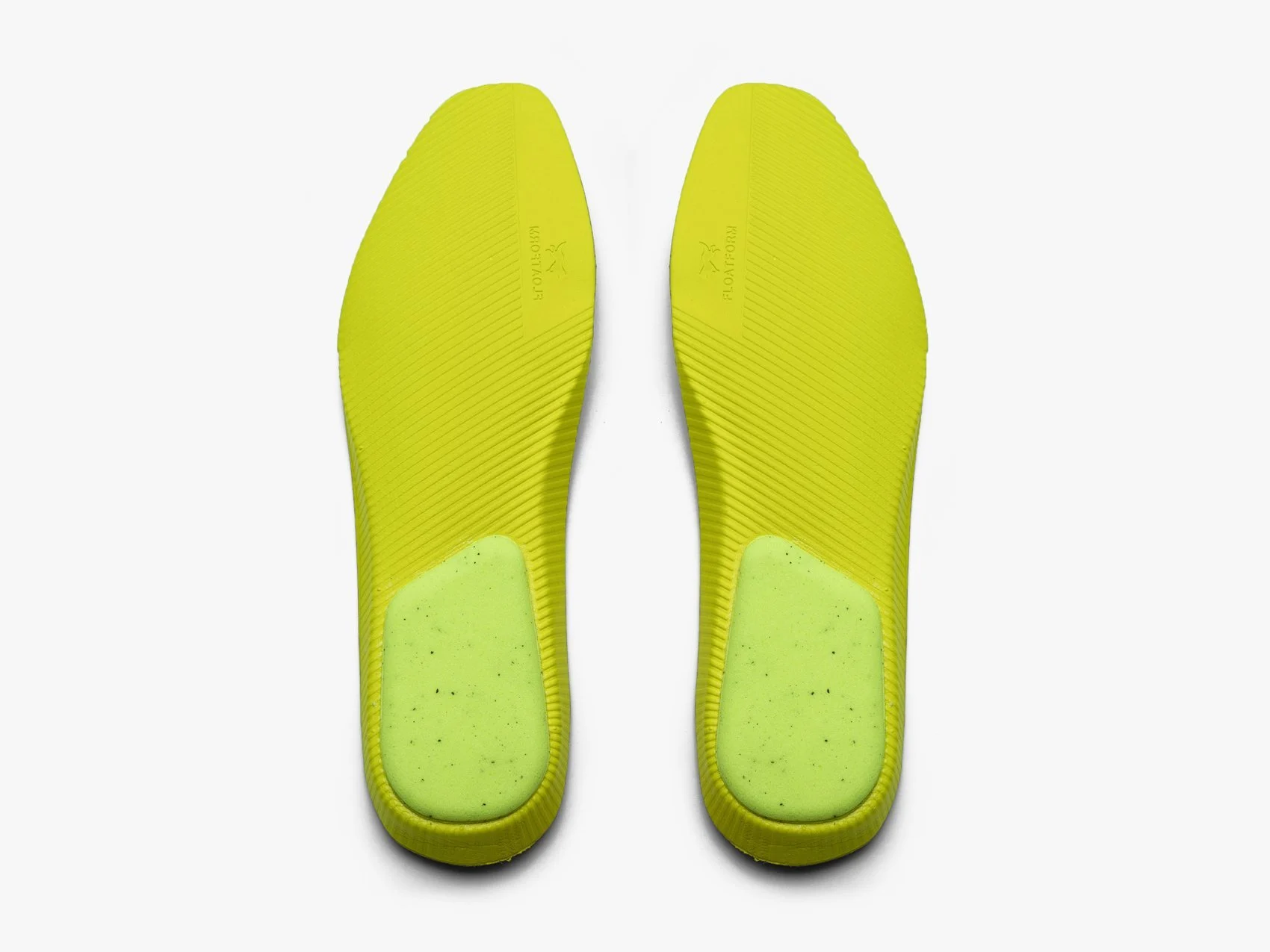 Detail view of a pair of yellow footbeds on a white background