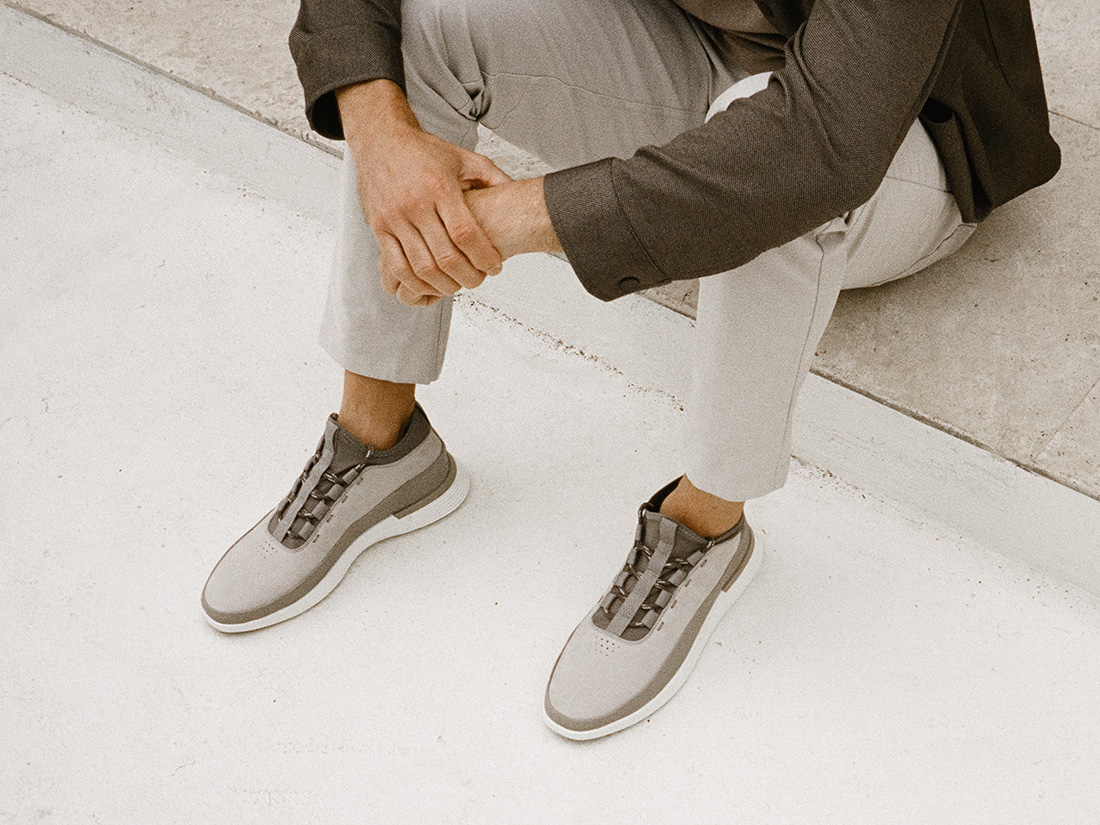 Knee down view of man wearing Crossover Hybrid Dress shoe in Mocha 