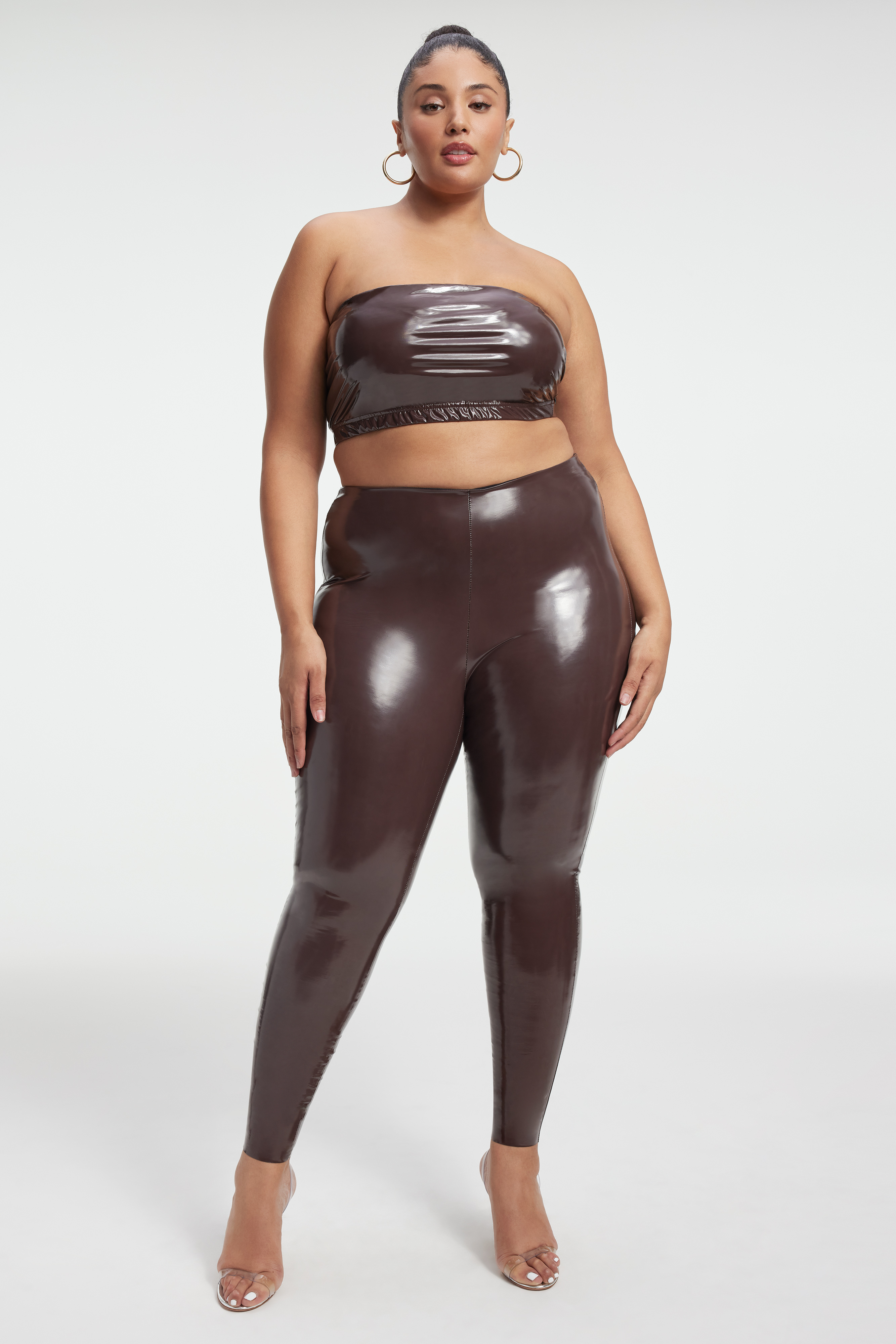 VINYL LEGGINGS in DARK COCOA001 styled with our VINYL BANDEAU in DARK COCOA001, VINYL HIGH-NECK BODYSUIT in DARK COCOA001, or VINYL CORSET BODYSUIT in DARK COCOA001