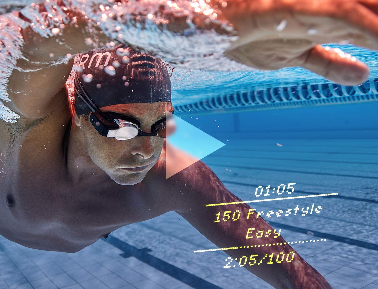A swimmer wearing Form swim goggles with the in-goggle display showing the intensity of workout, time, and pace in real-time