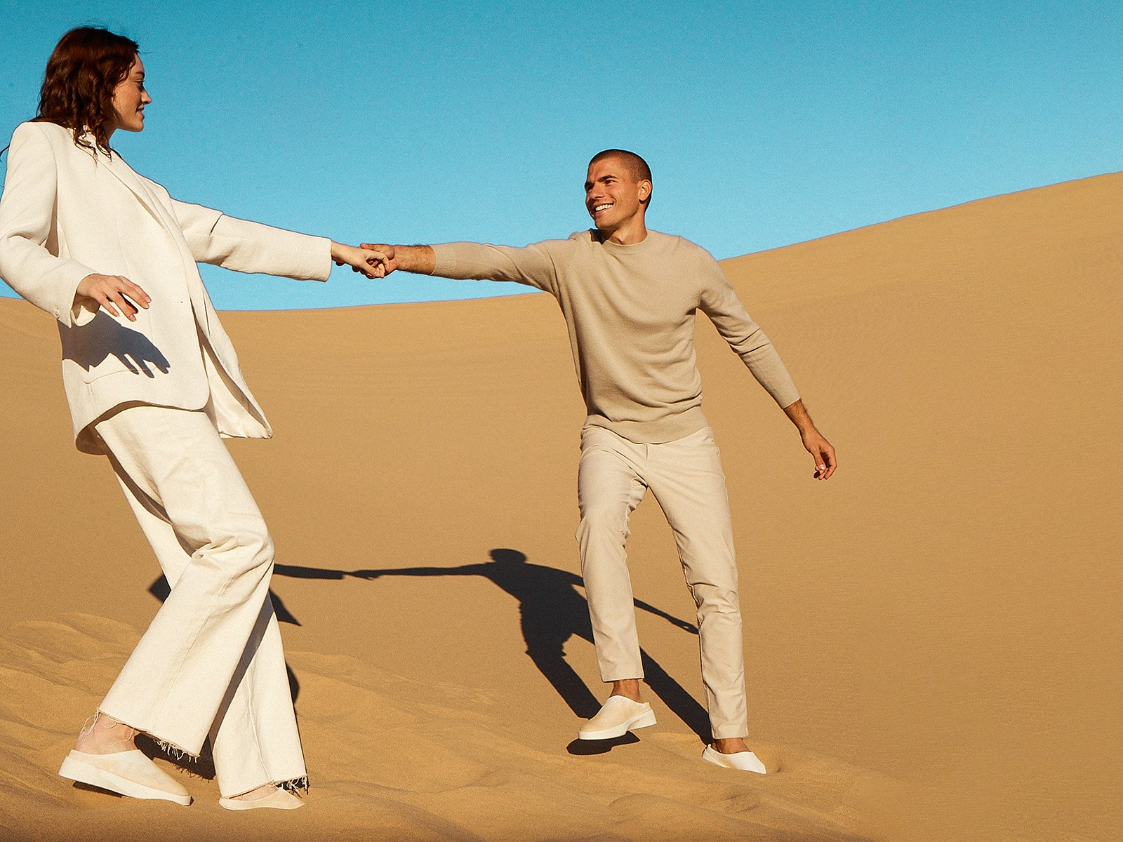 Man and woman in the desert holding hands wearing Cruise Slip on shoes