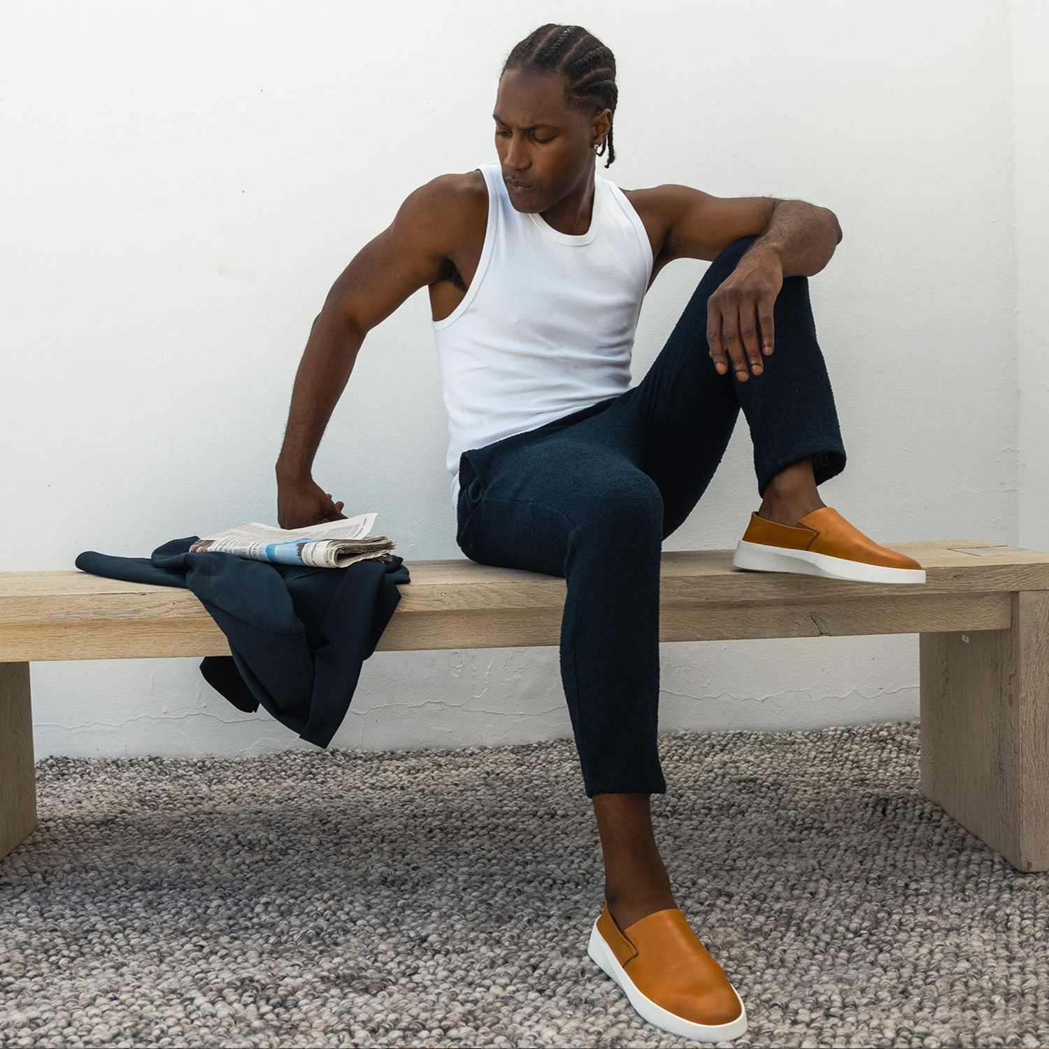 Full body view of man sitting on a bench wearing Men's Shoe Cruise Slip on Honey