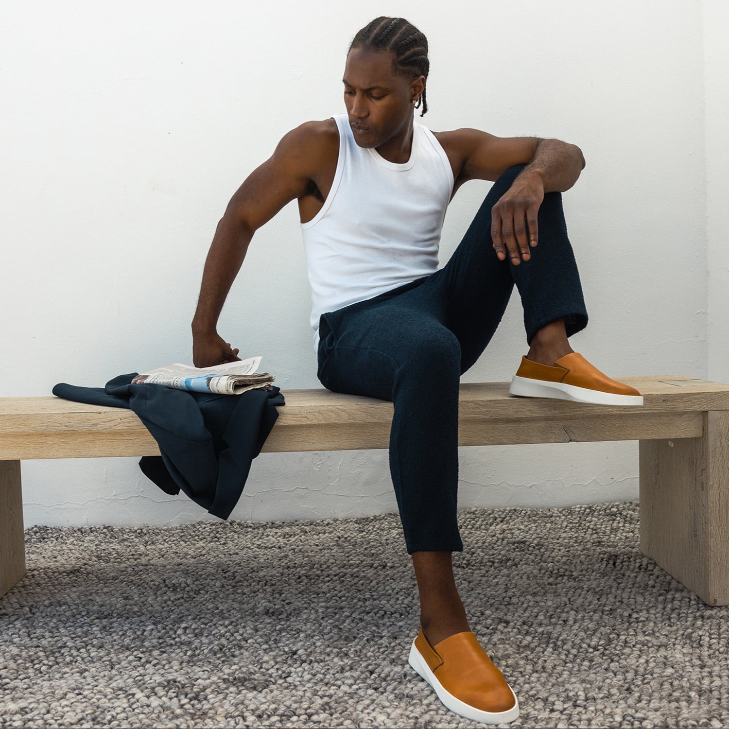 Full body view of man sitting on a bench wearing Men's Shoe Cruise Slip on Honey