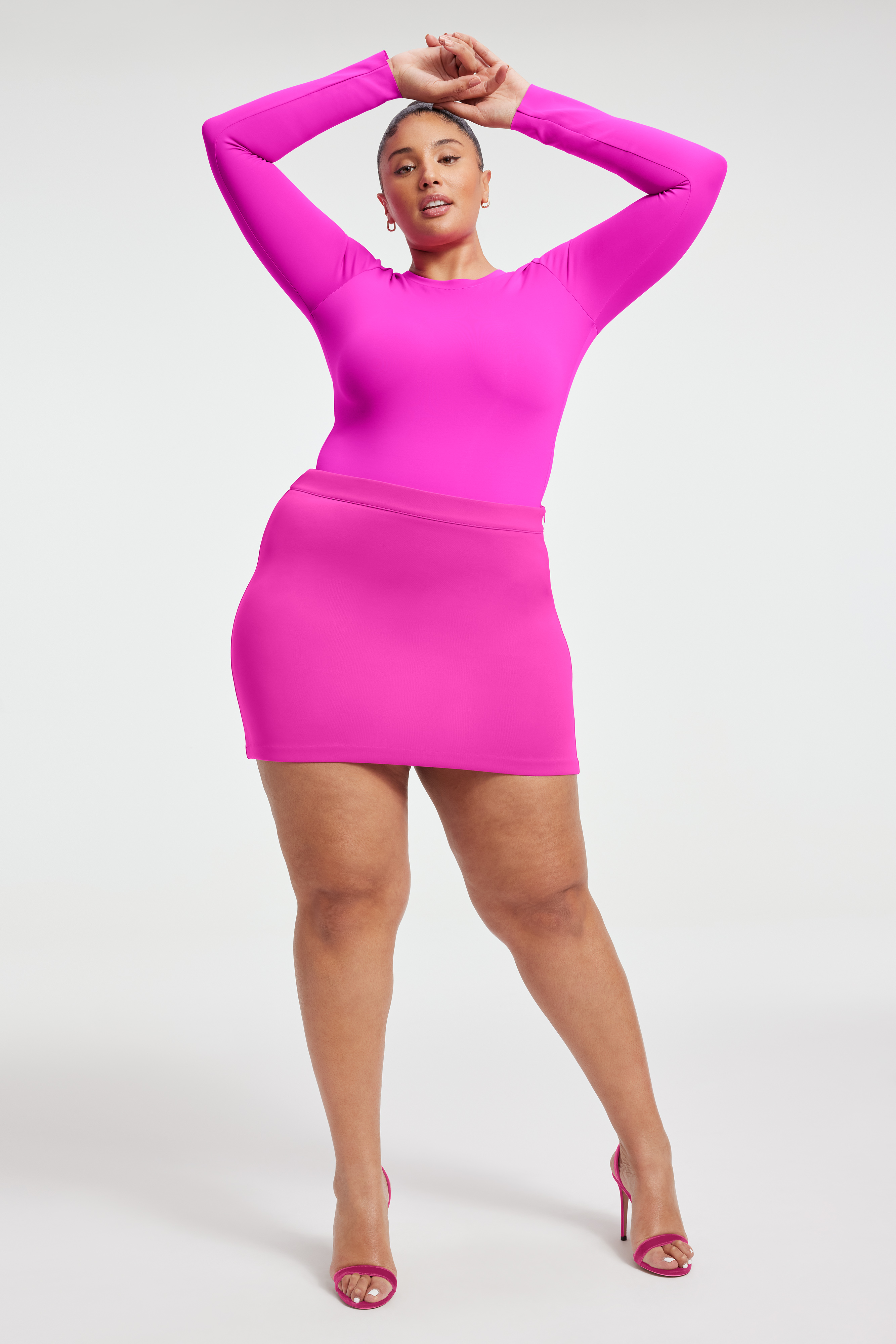 SCUBA MINI SKIRT in FUCHSIA PINK001 styled with our COMPRESSION SHINE CORSET BODYSUIT in FUCHSIA PINK001, or SUPER STRETCH BABY TEE in FUCHSIA PINK001