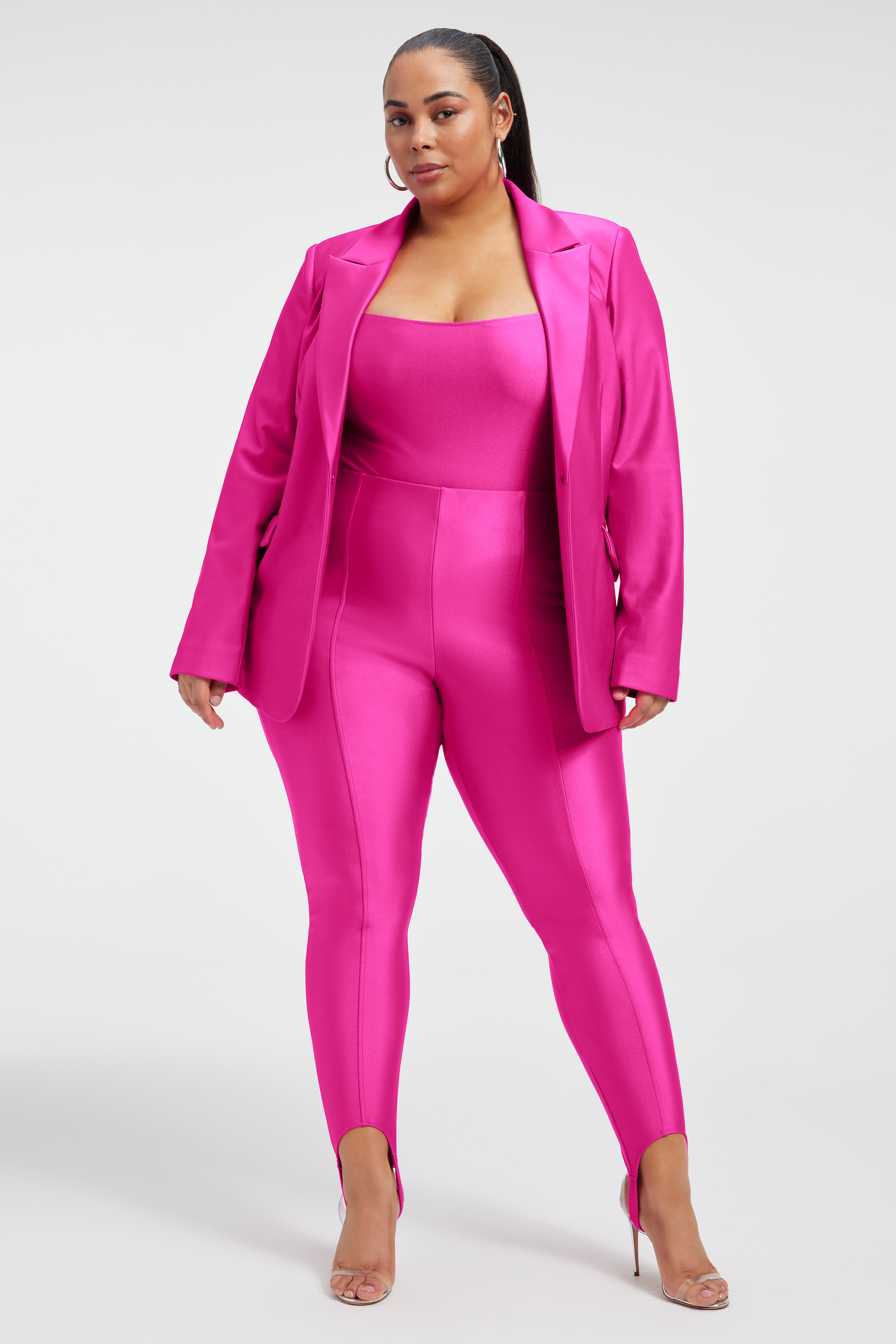 COMPRESSION SHINE STIRRUP PANTS in FUCHSIA PINK001 styled with our COMPRESSION SHINE CORSET BODYSUIT in FUCHSIA PINK001, COMPRESSION SHINE SCULPTED BLAZER in FUCHSIA PINK001, or SCUBA 2.0 BLAZER in FUCHSIA PINK001