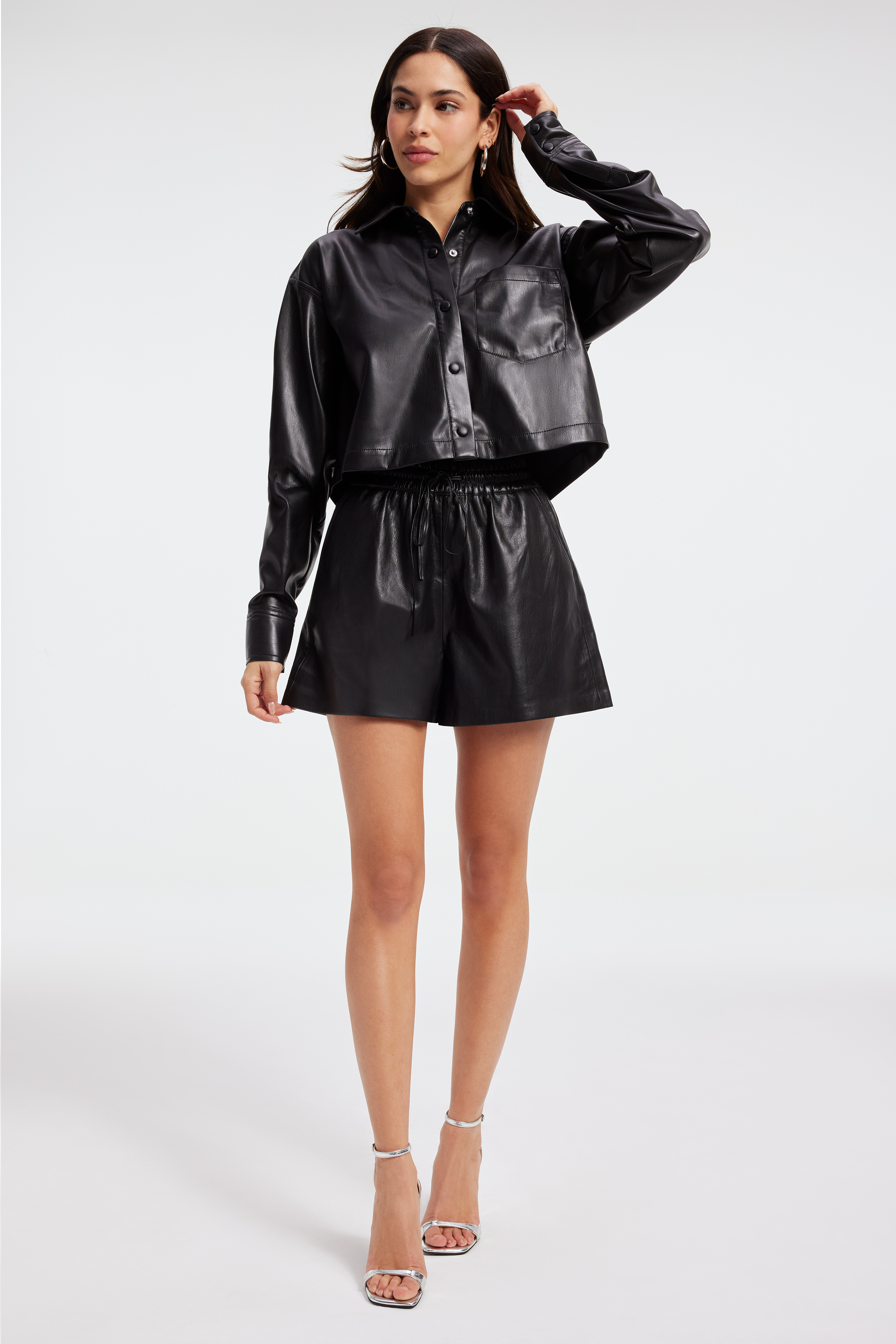 FAUX LEATHER CROP SHIRT in BLACK001 styled with our FAUX LEATHER MINI SKIRT in BLACK001, GOOD '90s JEANS in INDIGO348, or FAUX LEATHER SHORT in BLACK001