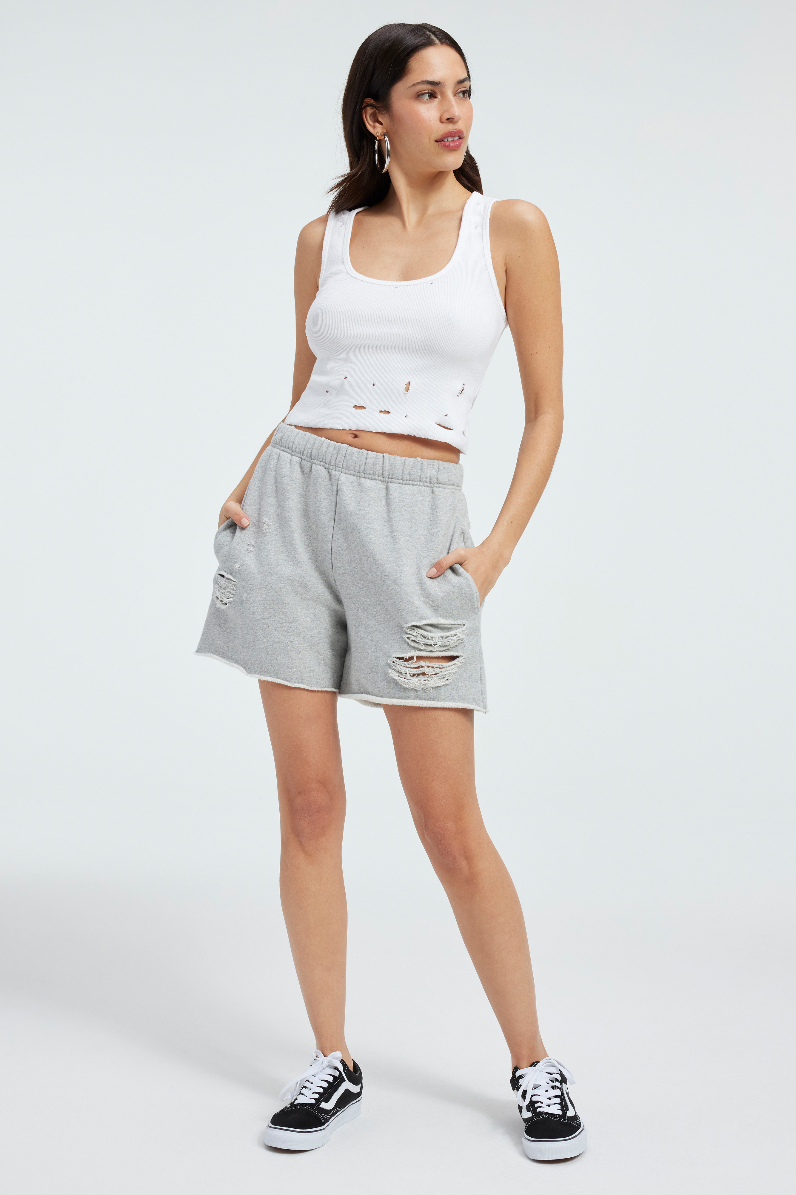 DISTRESSED FLEECE SHORTS in HEATHER GREY001 styled with our DISTRESSED RIB TANK TOP in IVORY001, DISTRESSED TEE in IVORY001, or FLEECE CROPPED SHACKET in HEATHER GREY001