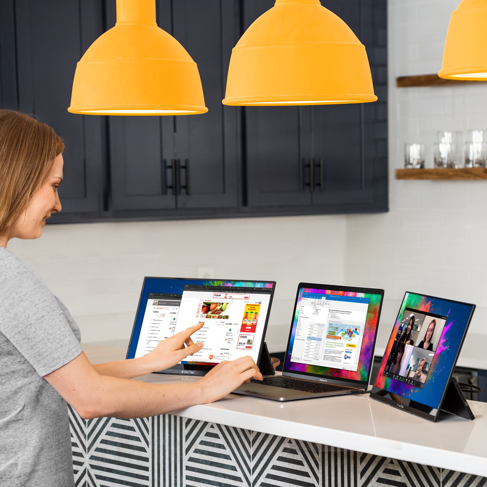 SideTrak Solo HD Triple woman working on triple screen setup in kitchen