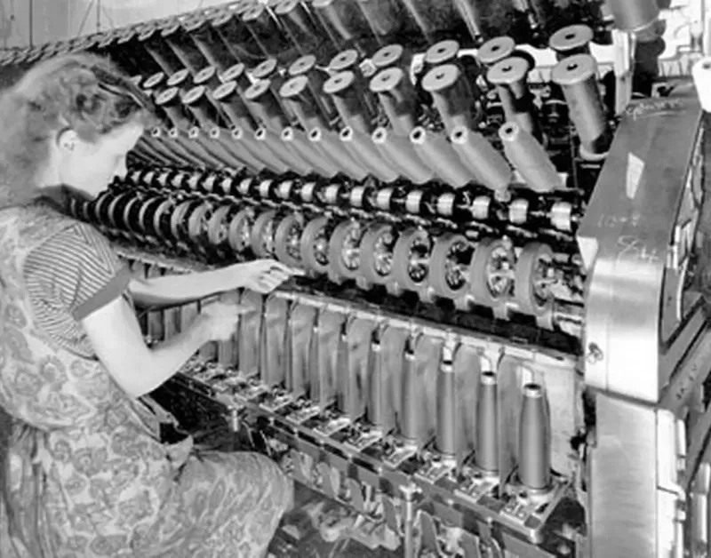 A woman operating a machine at Phoenox Textiles in the 1950s