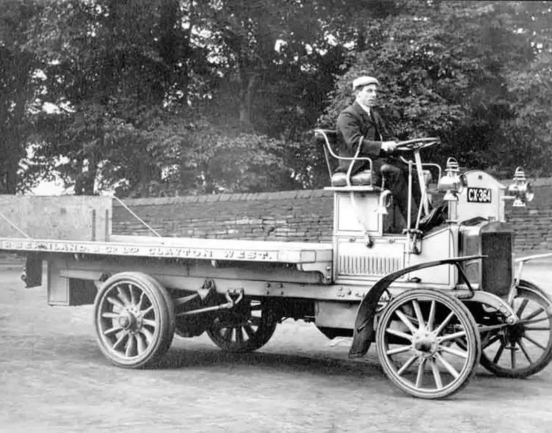 A man driving an old school vehicle around Phoenox Textiles in the 1950s