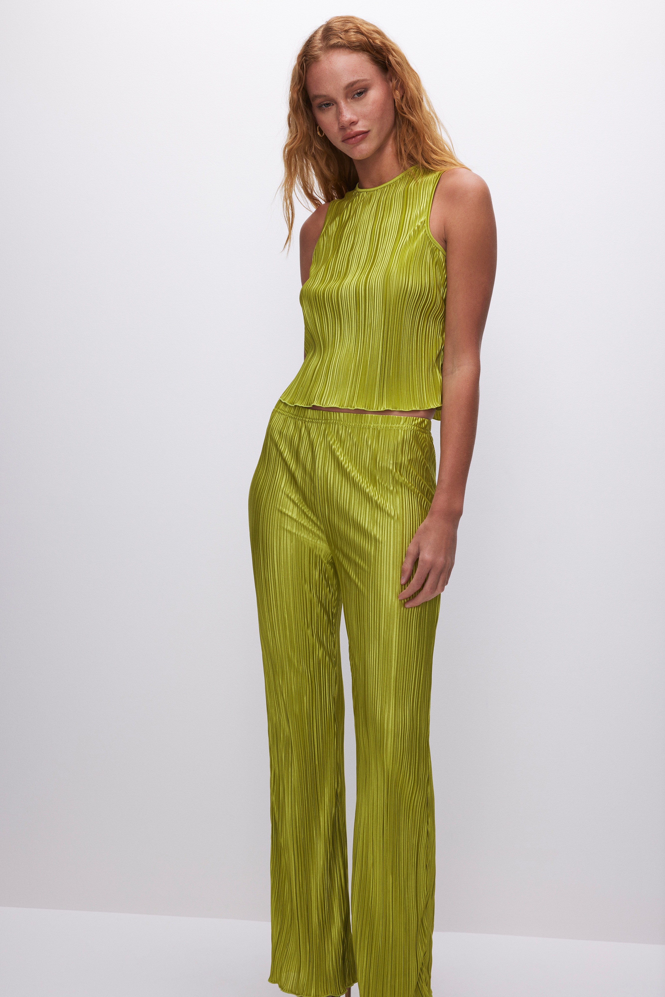 ALWAYS FITS PLISSÉ SHELL TANK in CHARTRUSSE001 styled with our ALWAYS FITS PLISSÉ PANTS in CHARTRUSSE001, ALWAYS FITS PLISSÉ SHORTS in CHARTRUSSE001, or ALWAYS FITS PLISSÉ MAXI SKIRT in CHARTRUSSE001