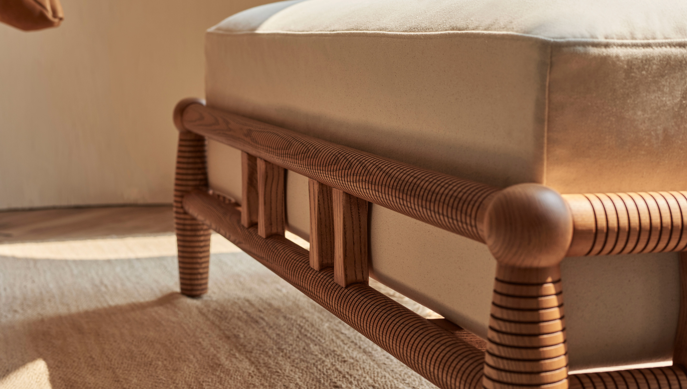 Close up view of the wooden frame of the Gio Dining Bench