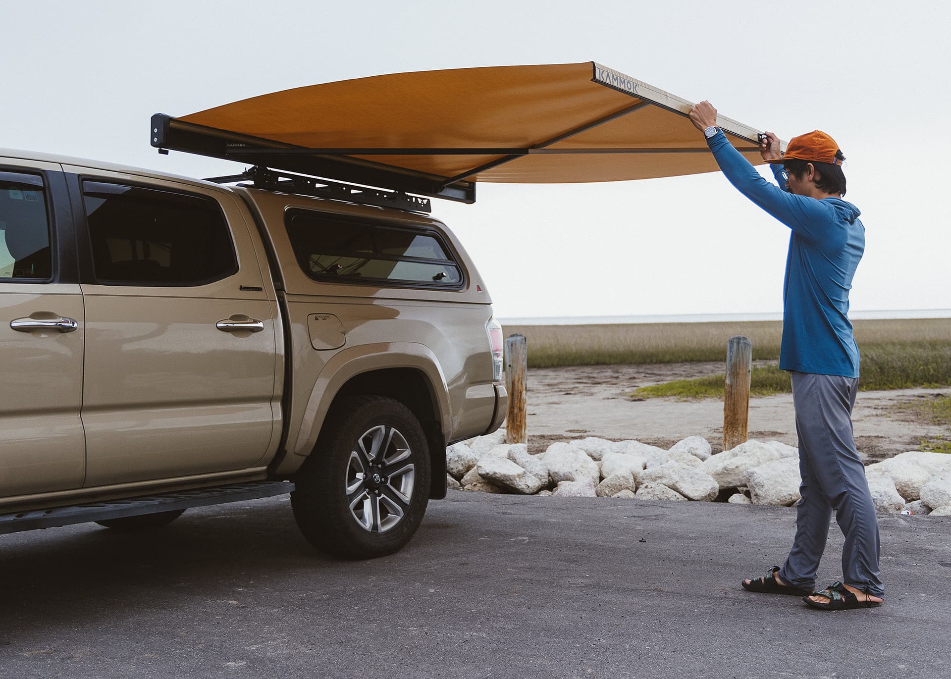 Man adjusting Man deploying Crosswing awning.