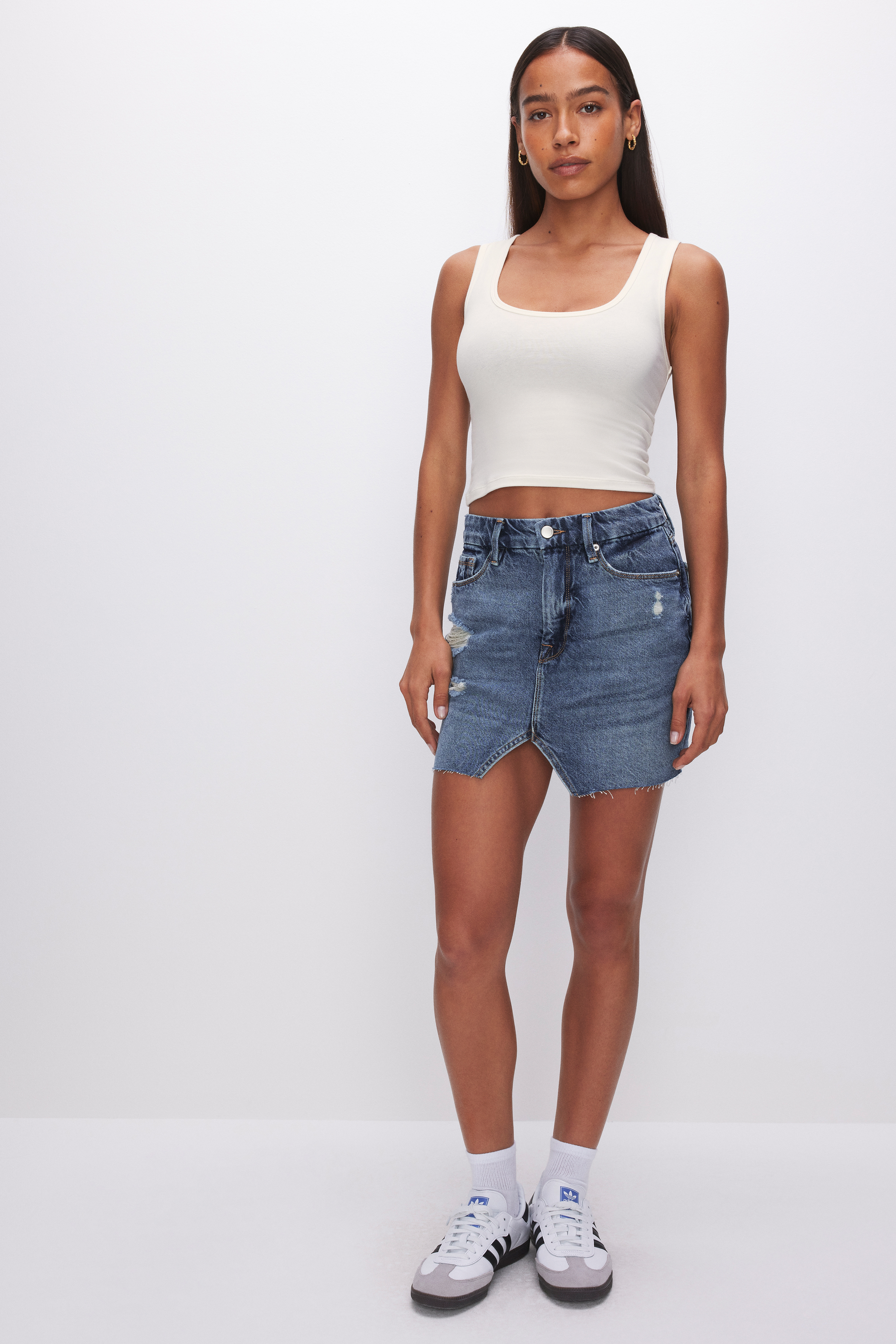 SUPER STRETCH COTTON SCOOP TANK in CLOUD WHITE001 styled with our DENIM MINI SKIRT in INDIGO496, BOMBSHELL SHORTS in INDIGO301,