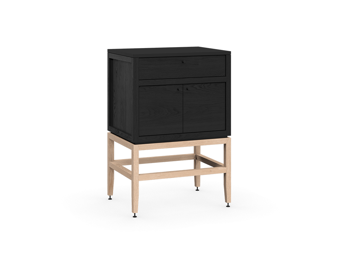 Coquo modular kitchen cabinet with two doors and one drawer in black stained oak and natural oak with metal handles.