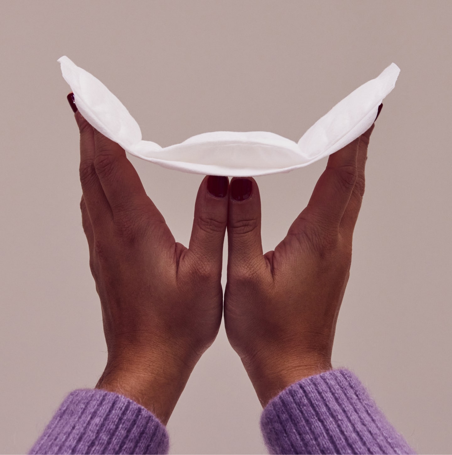Two hands holding an opened pad
