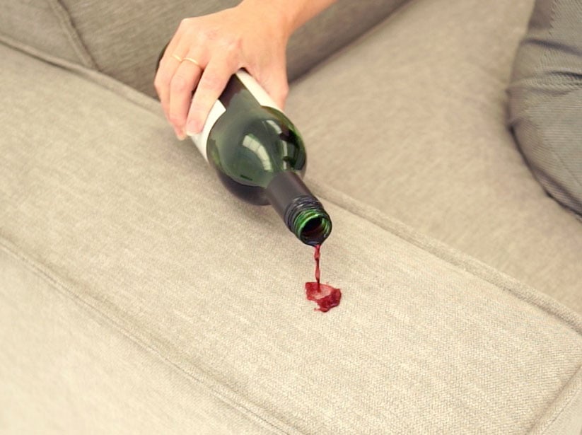 Red Wine being poured onto the arm of Model 03 Pumice to demonstrate stain resistance
