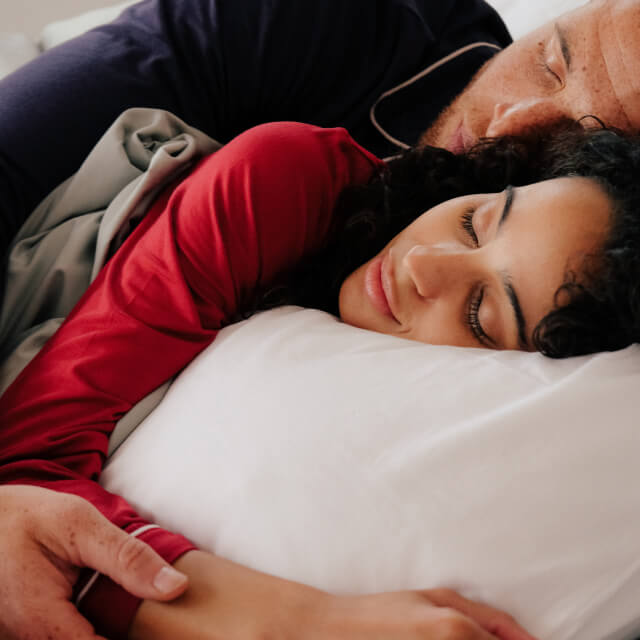 A man and woman sleeping closely using the Slumber Cloud Core Pillow Covers