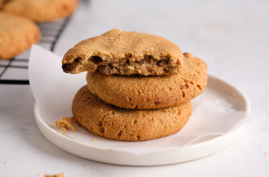 A stack of cookies on a white plate.