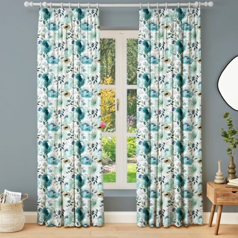 blue peony curtains next to wooden table and plant