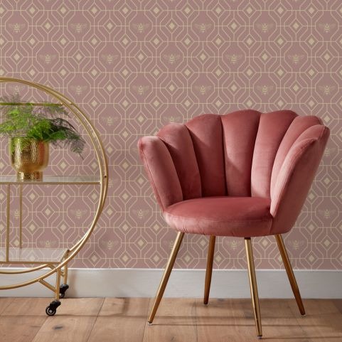 bee deco blush wallpaper next to pink cushioned chair and stand