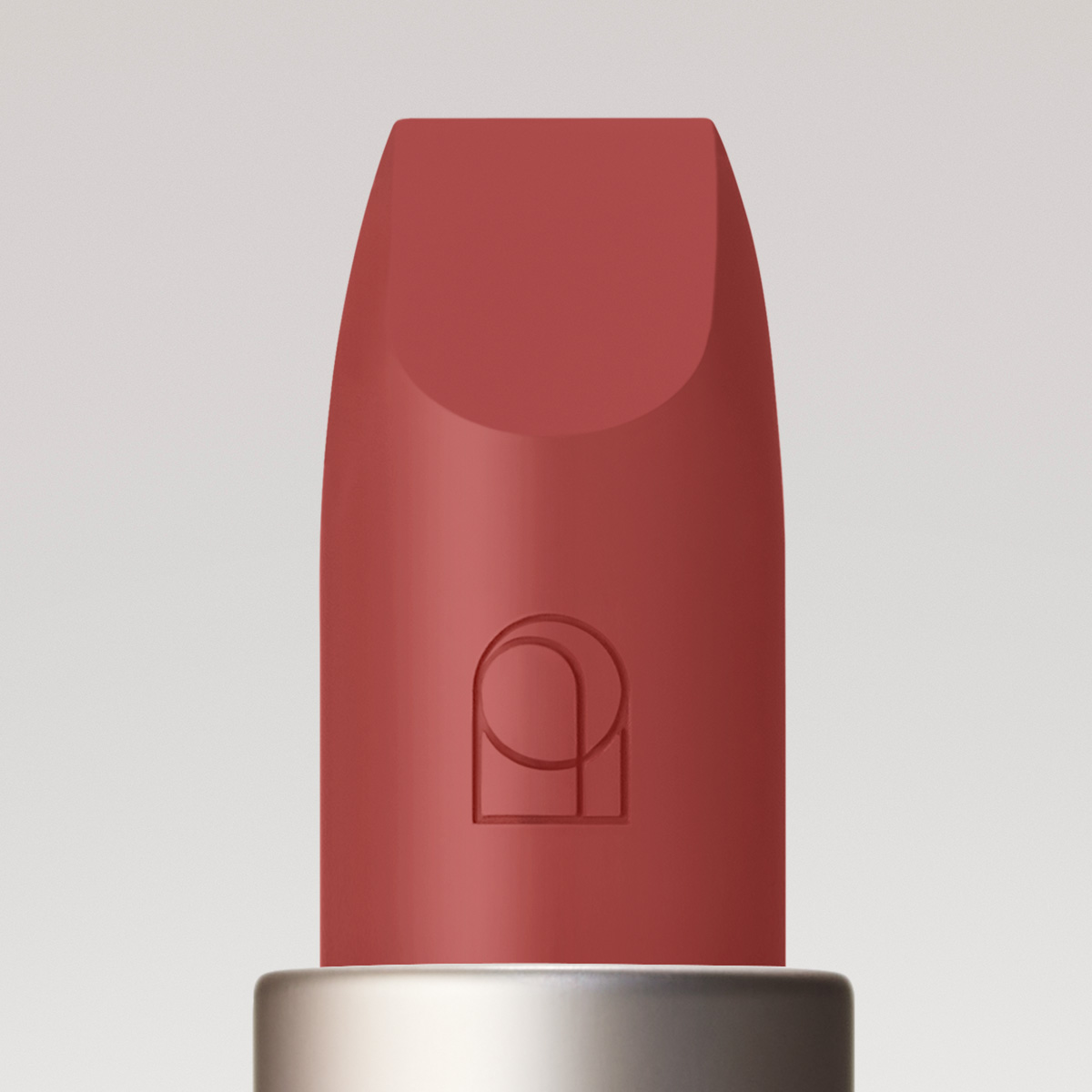 Close up image of the Satin Lipstick bullet with Rose Inc logo detail