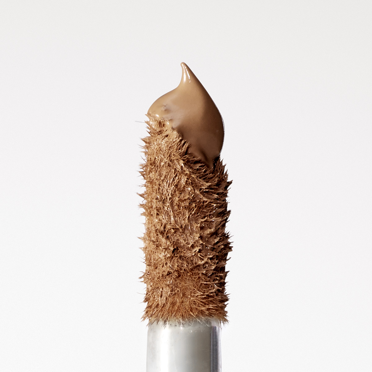 Zoomed in image of the applicator for the Rose Inc Softlight Concealer with light-medium concealer shade on tip