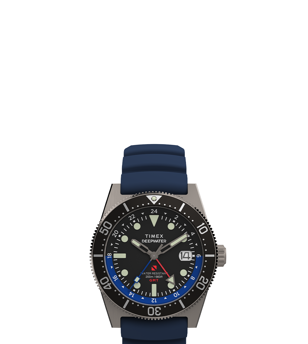 Clean render of the Timex Deepwater Reef 200 GMT watch. It features a dark dial, red GMT hand, dual-tone blue/black bezel, and a navy blue silicone strap.