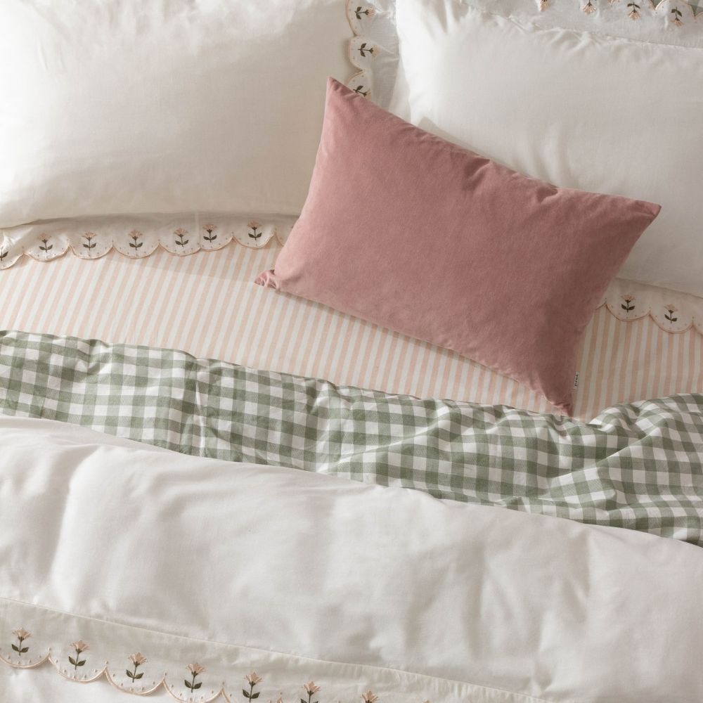 Pattern clashing with check duvet cover, striped bed spread and floral edge cushions