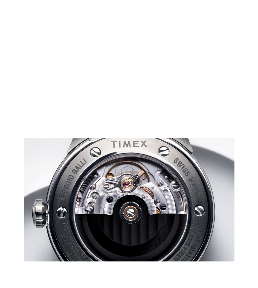 A detailed look at the watch’s Swiss-made automatic movement through the exhibition case back, displaying the intricate gears, balance wheel, and fine finishing of the mechanism.