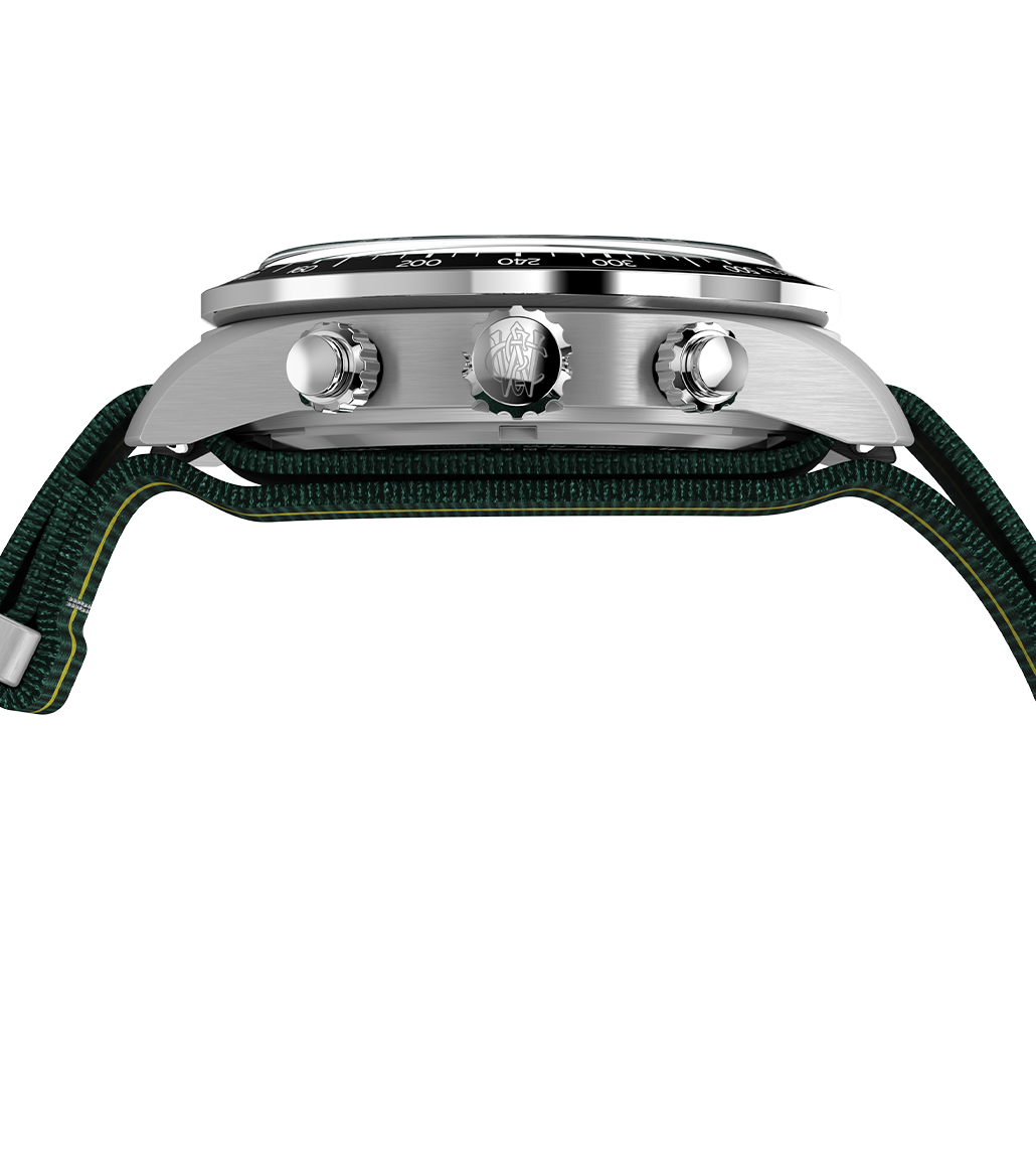 Side view of the Timex Waterbury Heritage Chronograph displaying its brushed stainless steel case, signed crown with Waterbury “W” emblem, chronograph pushers, and a slightly domed crystal over the bezel.