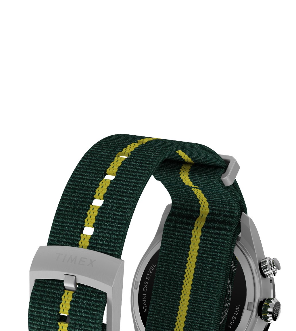 Close-up view of the strap on the Timex Waterbury Heritage Chronograph, made of green woven fabric with a yellow central stripe and matching green underside, secured with a brushed stainless steel buckle engraved with “TIMEX”.