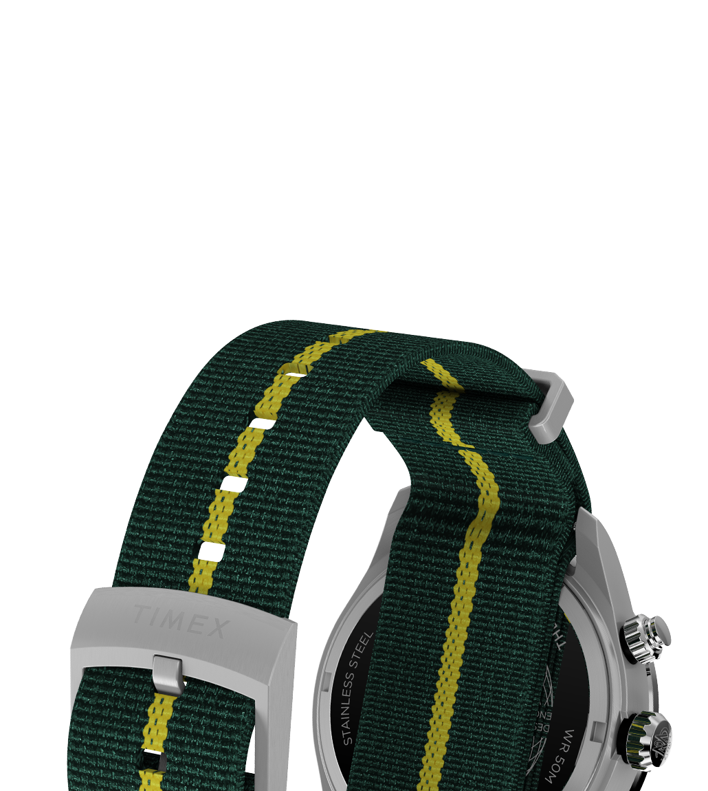 Close-up view of the strap on the Timex Waterbury Heritage Chronograph, made of green woven fabric with a yellow central stripe and matching green underside, secured with a brushed stainless steel buckle engraved with “TIMEX”.