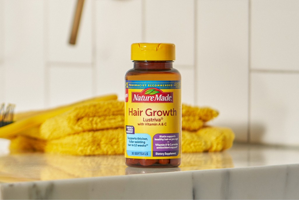 Nature Made Hair Growth supplement bottle on bathroom counter