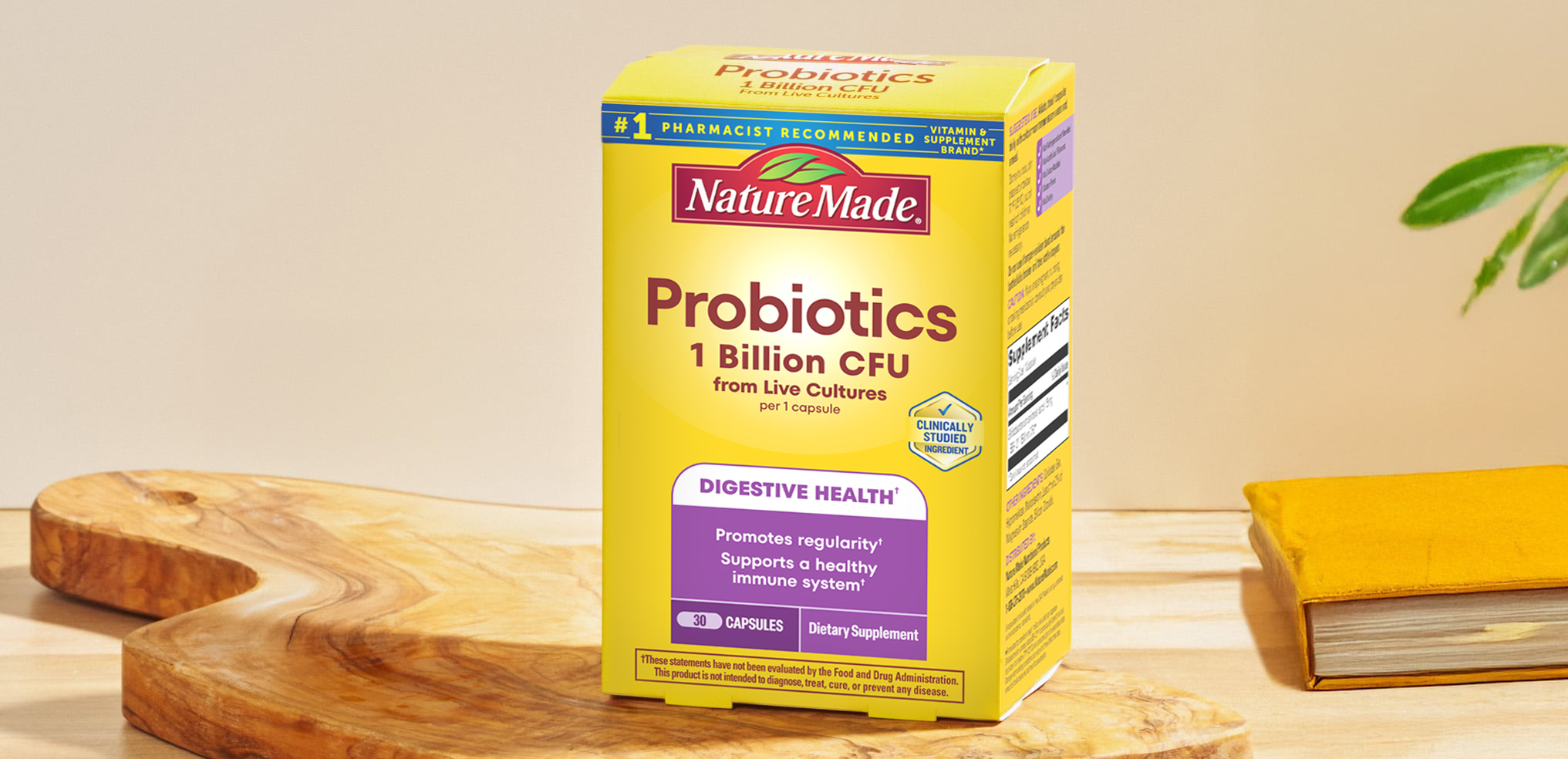 Nature Made Probiotics 1 Billion CFU From Live Cultures Capsules box on a cutting board next to a book.