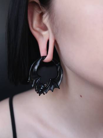 Girl wearing pretty Black Steel Bat Ear Weights - Pair