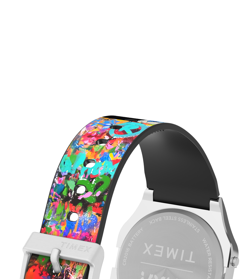 Rear view of the Timex T80 x TVBOY watch showing the stainless steel caseback engraved with Timex branding. The watch strap features a vivid, multi-colored graffiti design with turquoise and red spray paint motifs and a silver buckle engraved with 'TIMEX'.