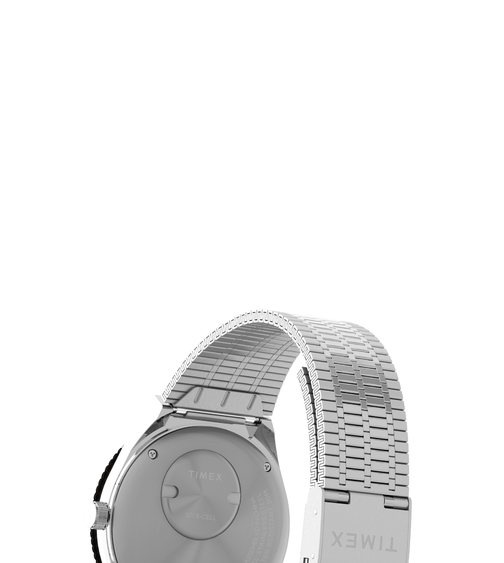 Rear view of the Timex x seconde/seconde/ Prequel Edition watch showing the brushed stainless steel caseback and expansion bracelet. 'TIMEX' is engraved on the clasp, with additional battery and model details etched on the back.