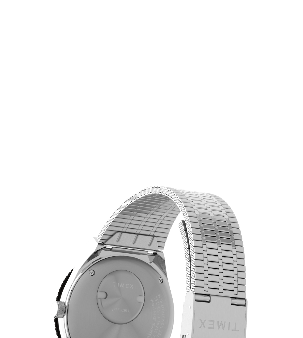 Rear view of the Timex x seconde/seconde/ Prequel Edition watch showing the brushed stainless steel caseback and expansion bracelet. 'TIMEX' is engraved on the clasp, with additional battery and model details etched on the back.