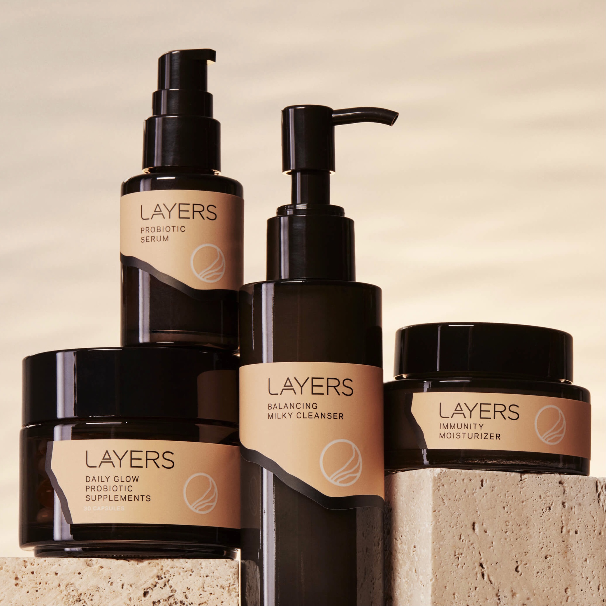 Layers Probiotic Skincare Group Product Shot with Semi-Transparent Glass Packaging and Pink Labels. For dry skin, oily skin, combination skin. 