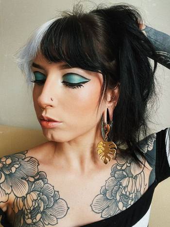 Girl wearing unique Gold Steel Monstera Leaf Ear Hangers - Pair