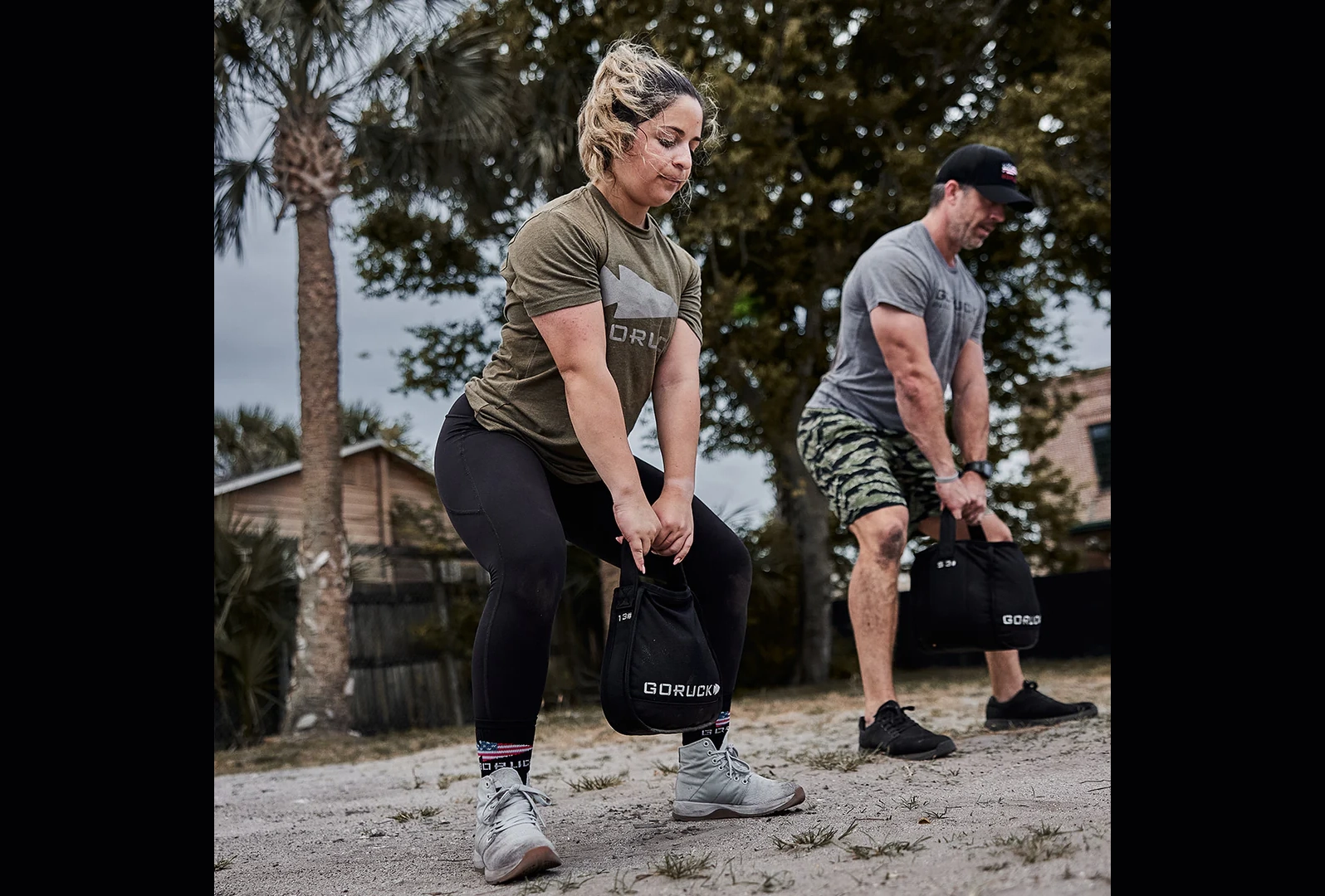 woman doing kettlebell swings with goruck sand kettlebell