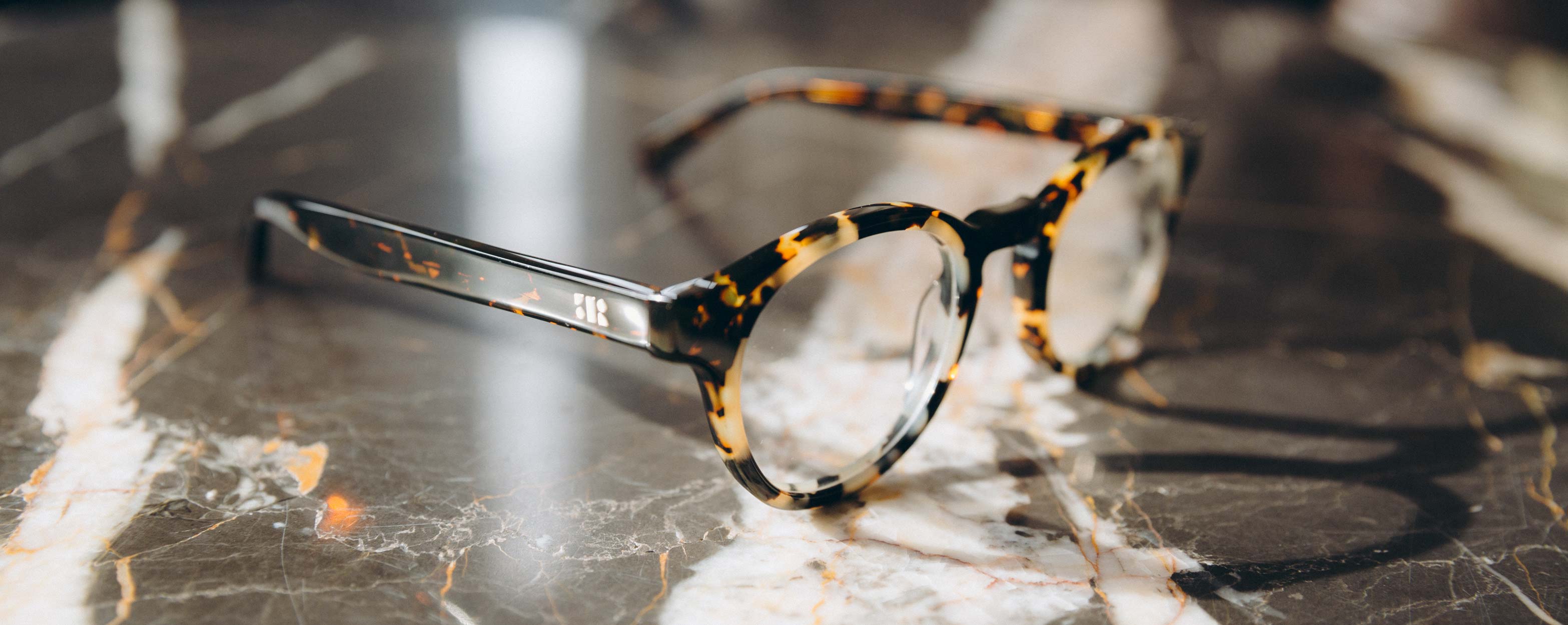 Photo Details of Alexis Clear Grey & Grey Marble Reading Glasses in a room