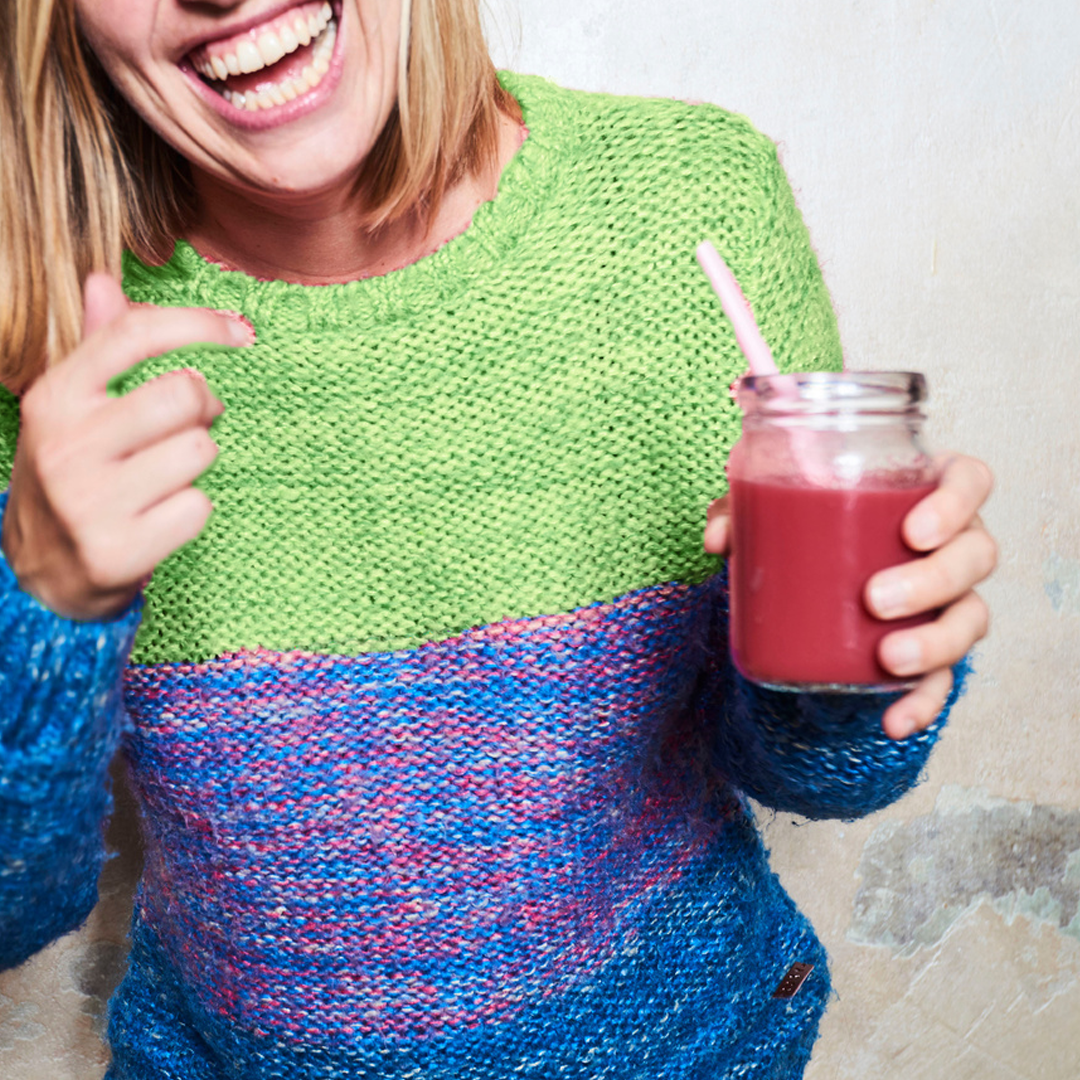 girl smiling with berry smoothie
