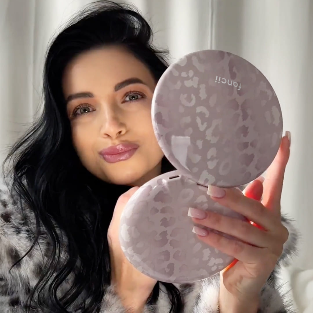 Woman using the Taylor lighted compact mirror