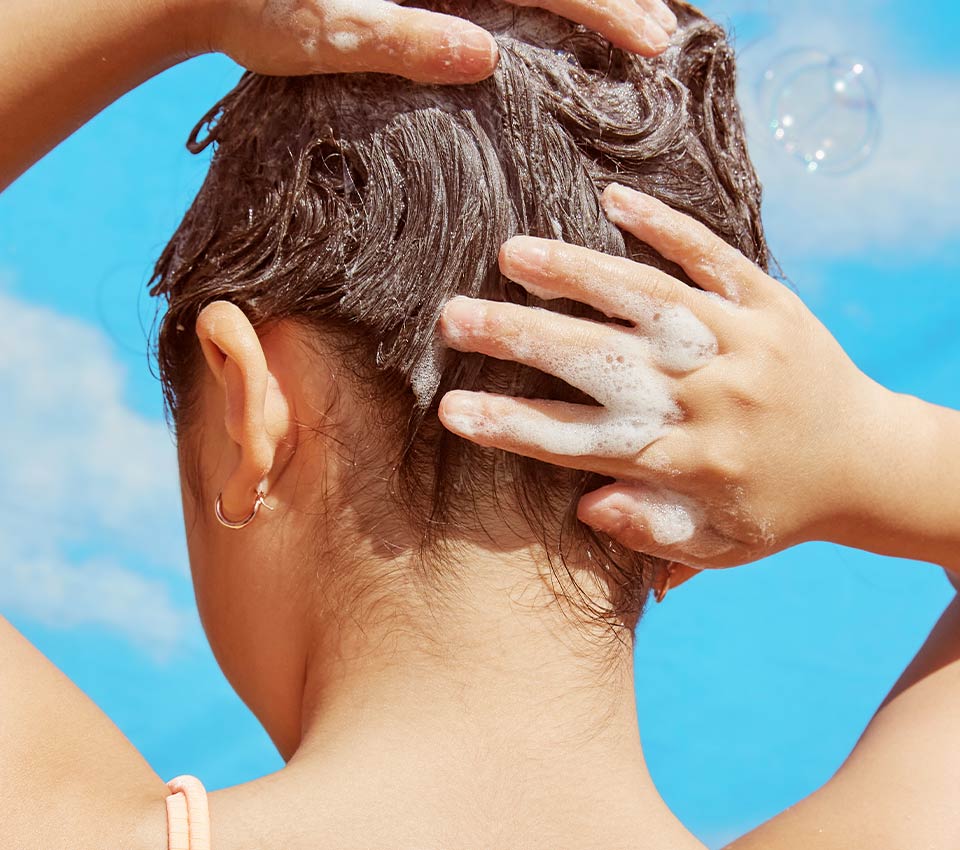 Person washing short hair with shampoo.