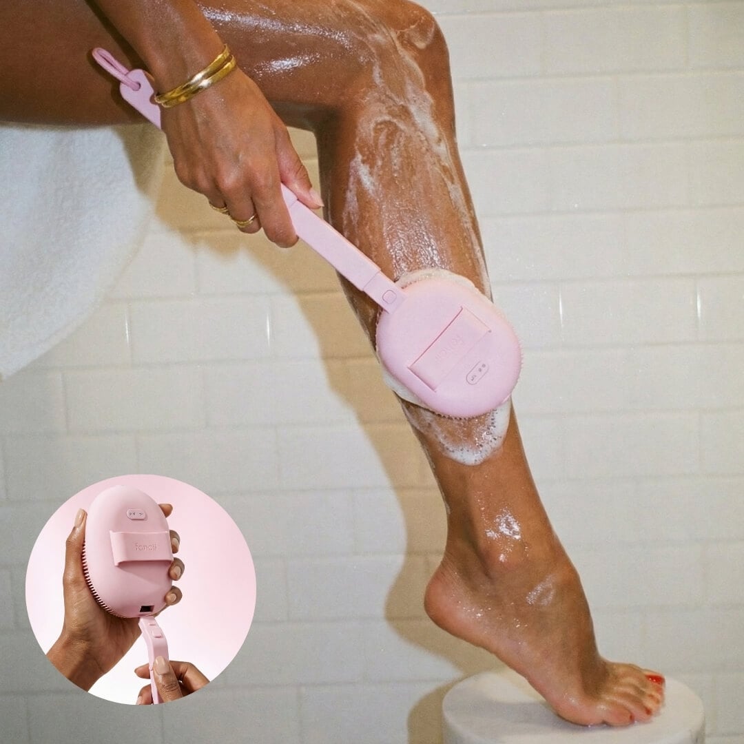 Nyla Sonic Body Brush being used to wash a leg