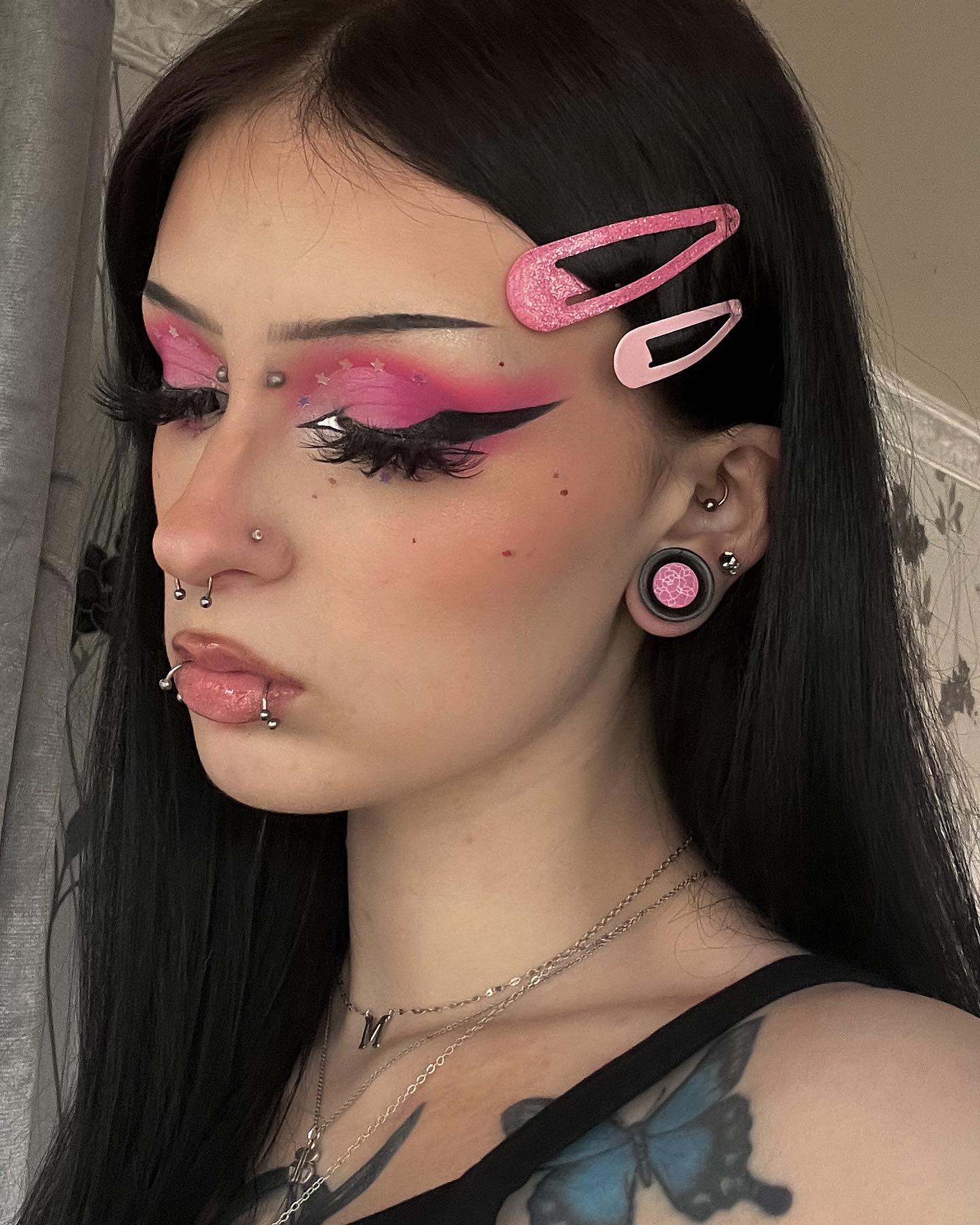 Girl wearing cute pink and white peony flower acrylic inlay and wood plugs