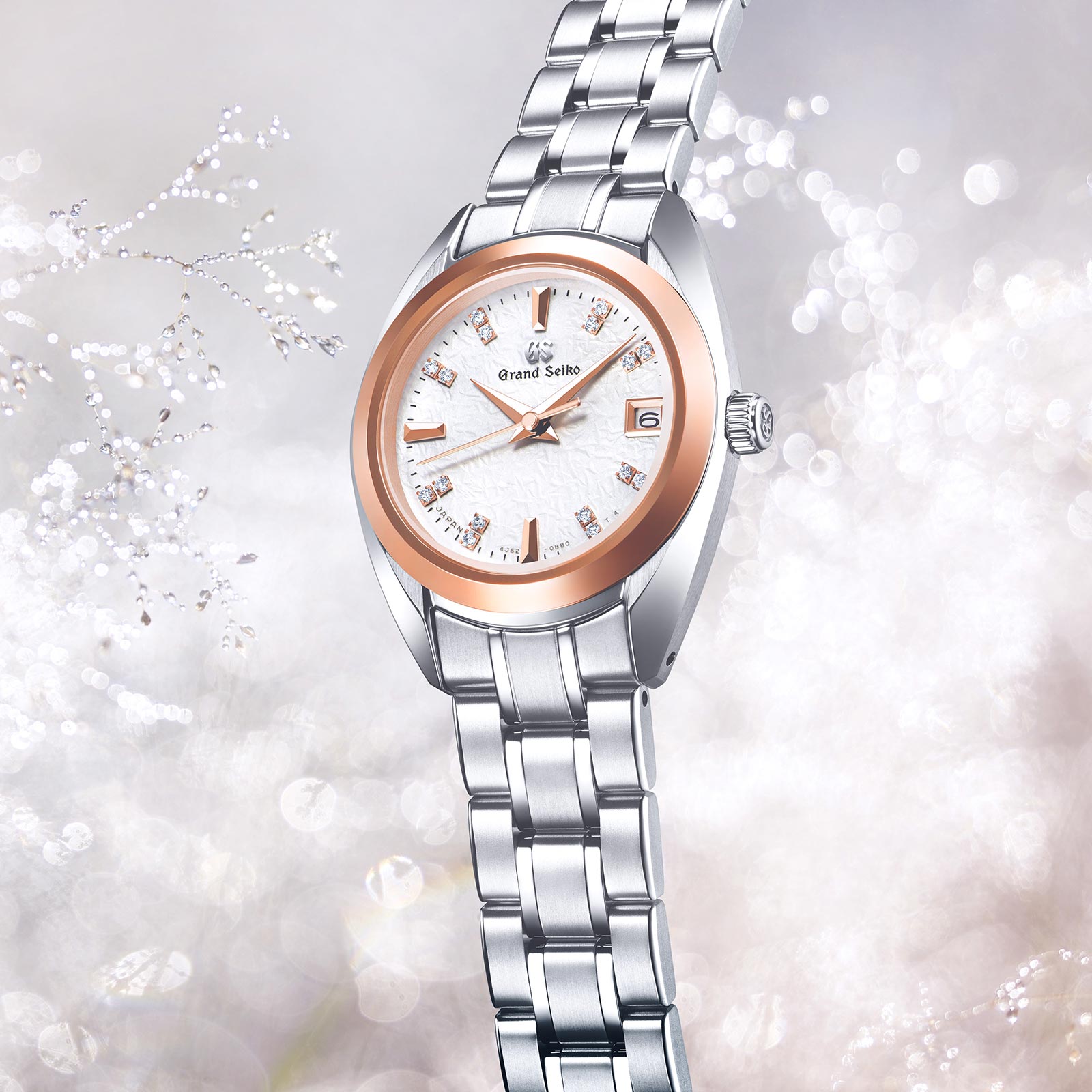 Ladies Grand Seiko watch STGF374 with white diamond dial and High-Intensity Titanium case and bracelet and rose gold bezel. 