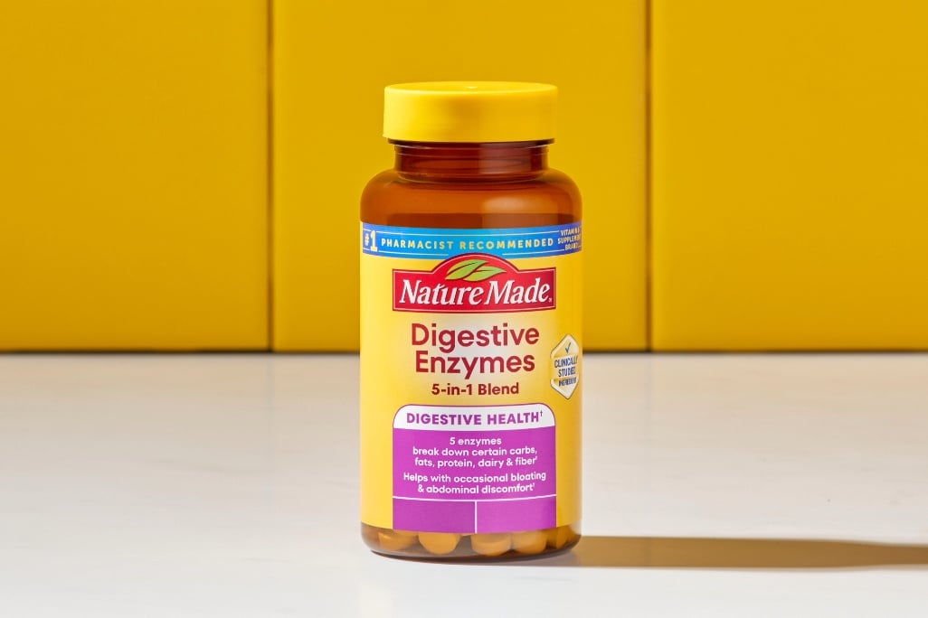 Nature Made Digestive Enzymes 5-in-1 Blend Chewable Tablets on a kitchen counter with a yellow tile background